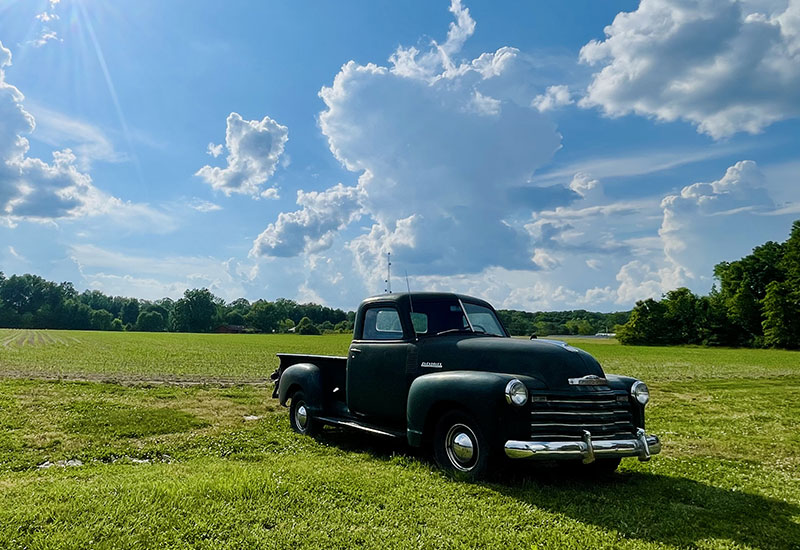 Old truck parked in a field