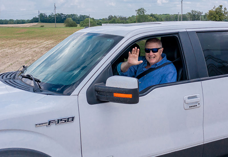 Man waving from a truck